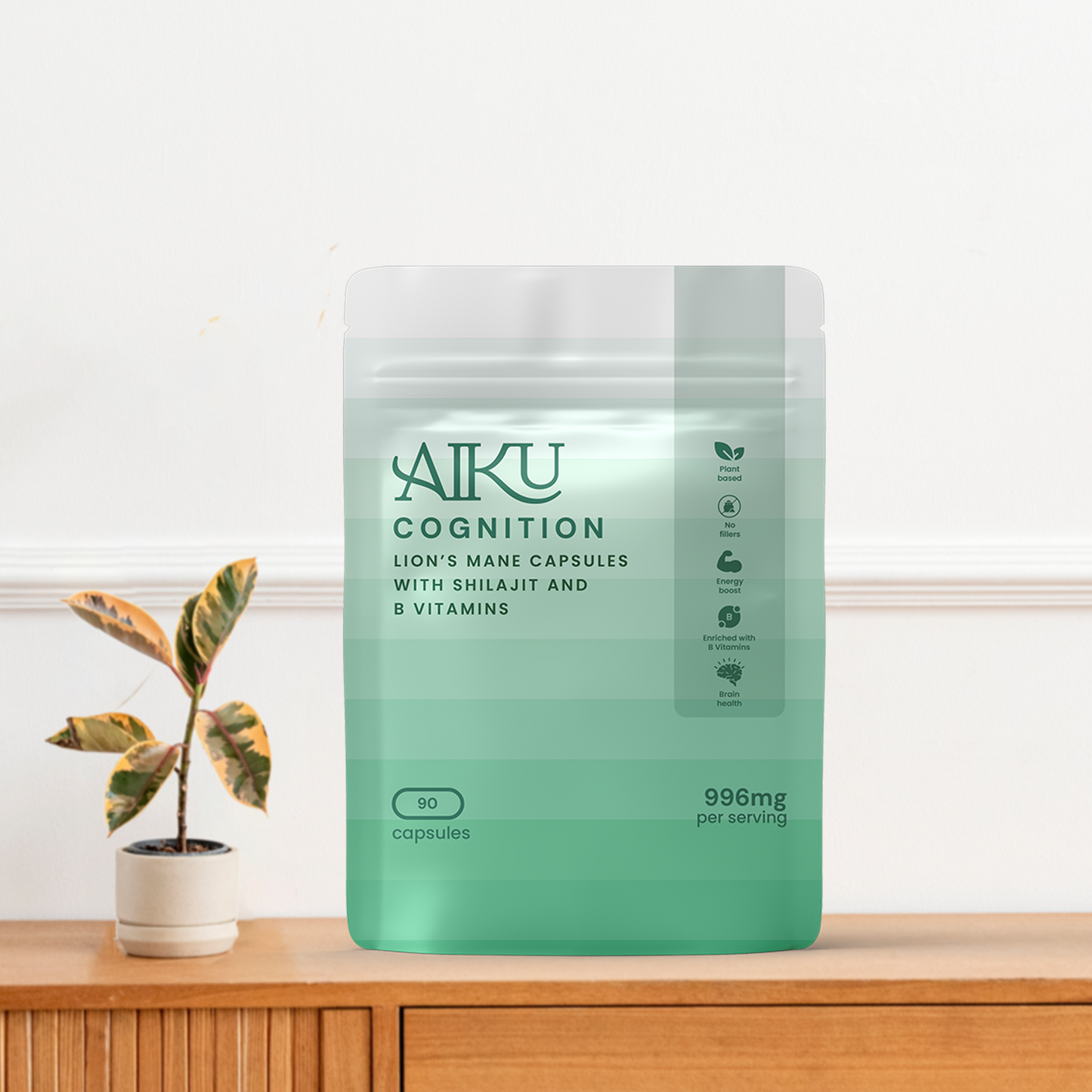 Green Aiku Cognition supplement package on a wooden surface with a plant in the background